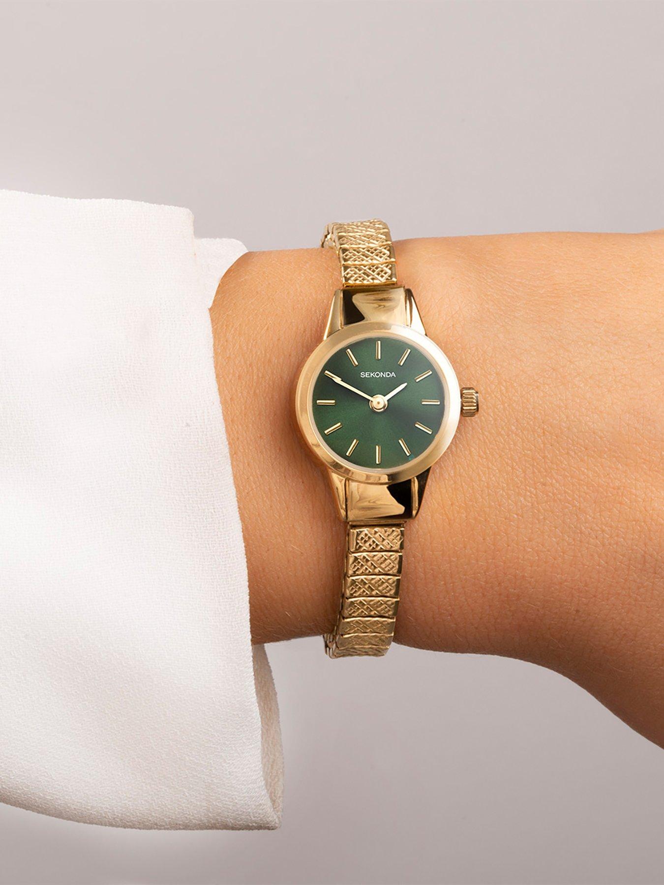 Women's gold watch with green online face