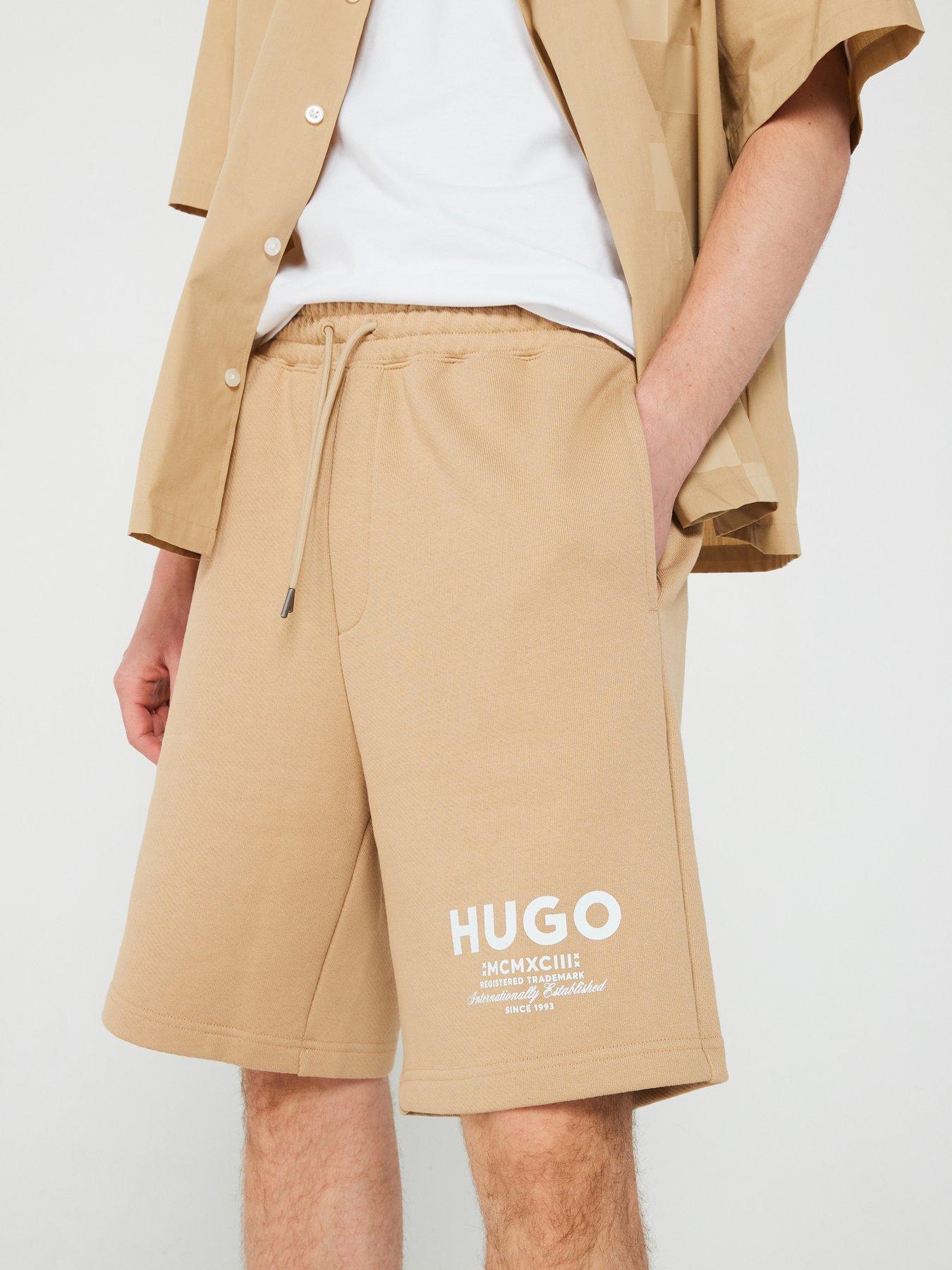 hugo-blue-nomario-oversized-international-logo-jersey-shorts-beigeoutfit