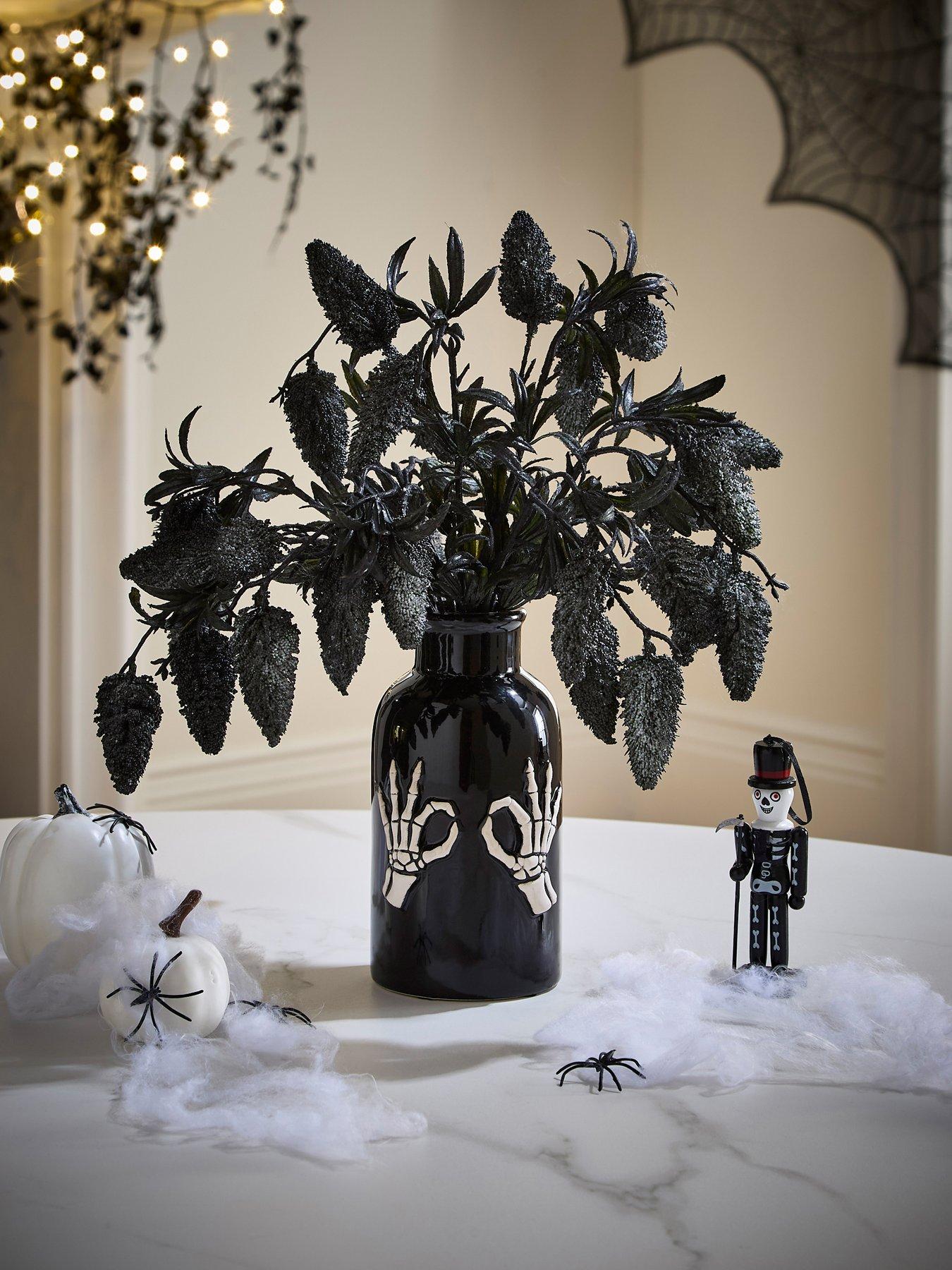 hocus-pocus-fruit-foliage-display-in-a-skeleton-hand-halloween-vase