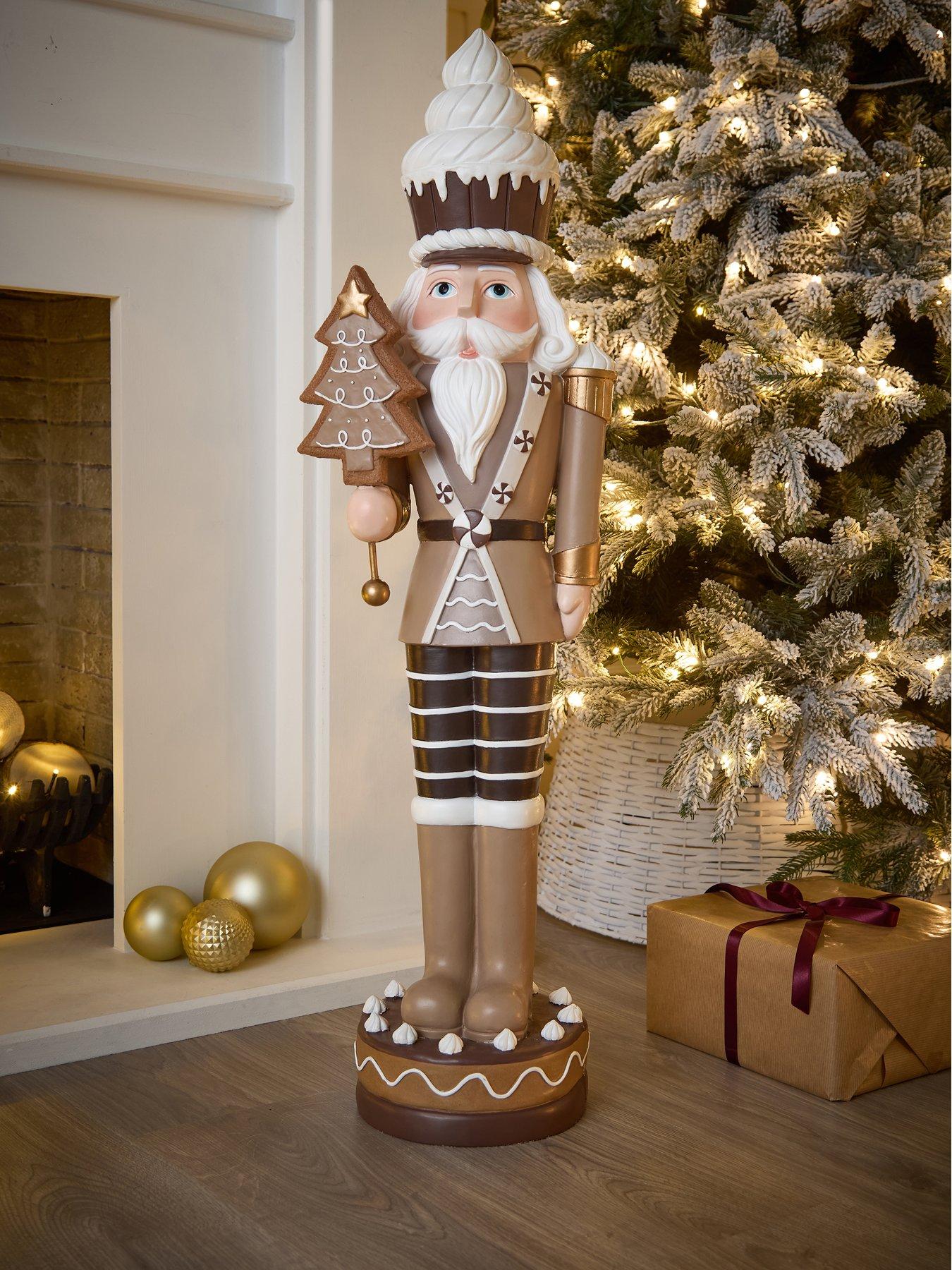 festive-93nbspcm-brownwhite-nutcracker-withnbspcake-hat-and-tree-christmas-decorationfront
