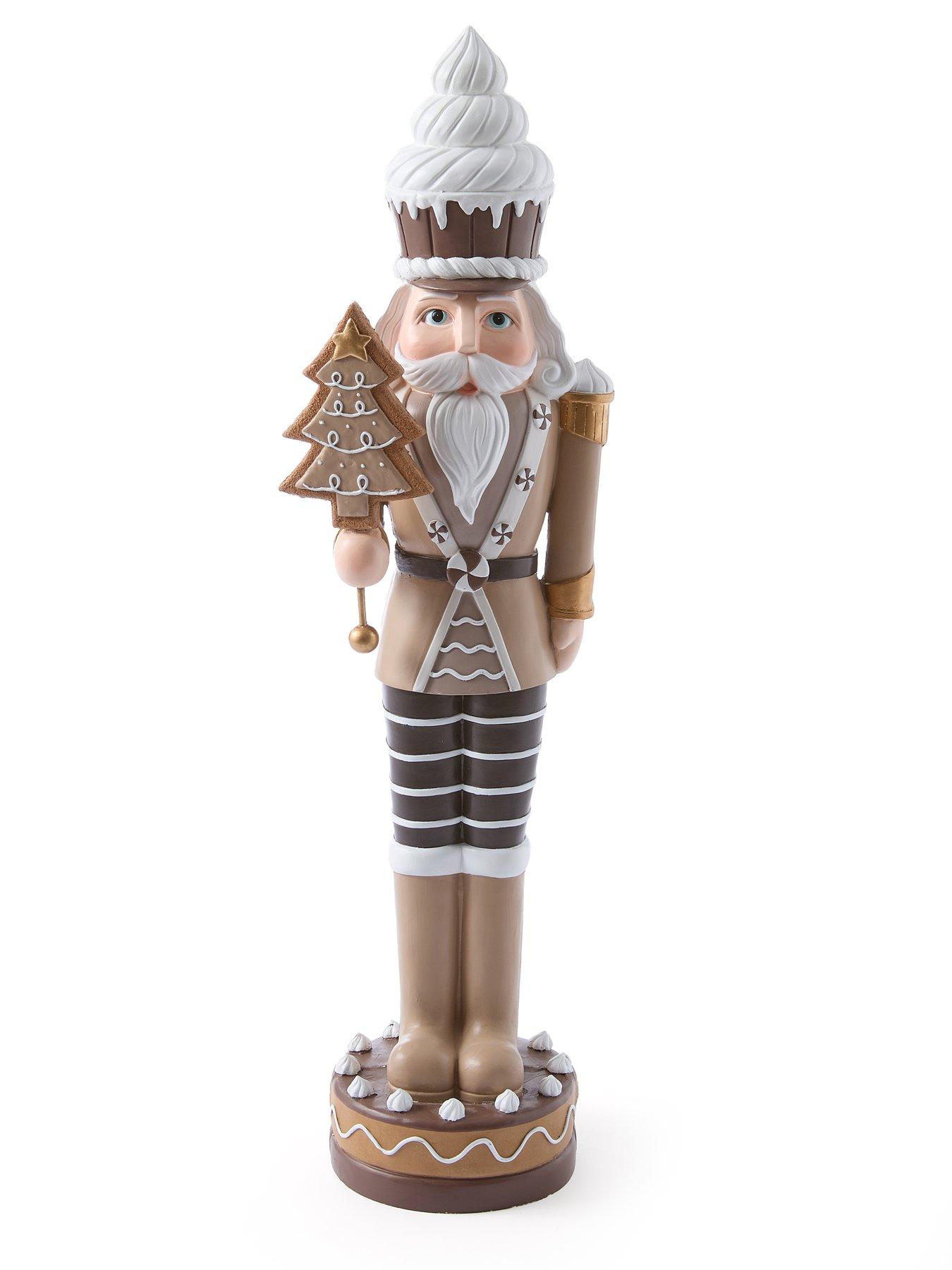 festive-93nbspcm-brownwhite-nutcracker-withnbspcake-hat-and-tree-christmas-decorationstillFront