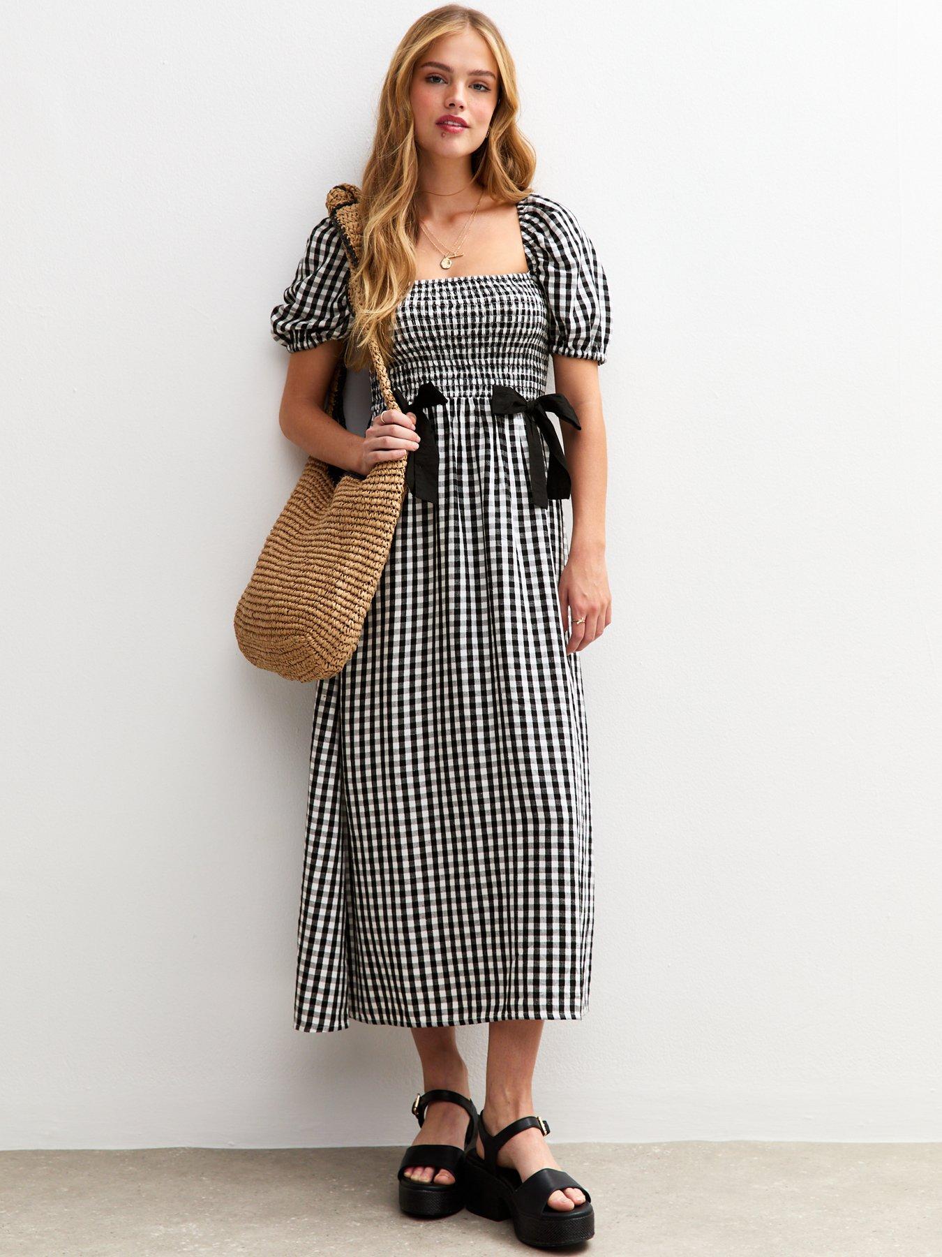 Image 1 of 4 of New Look Gingham Shirred Bow Front Midi Dress&nbsp;- Black
