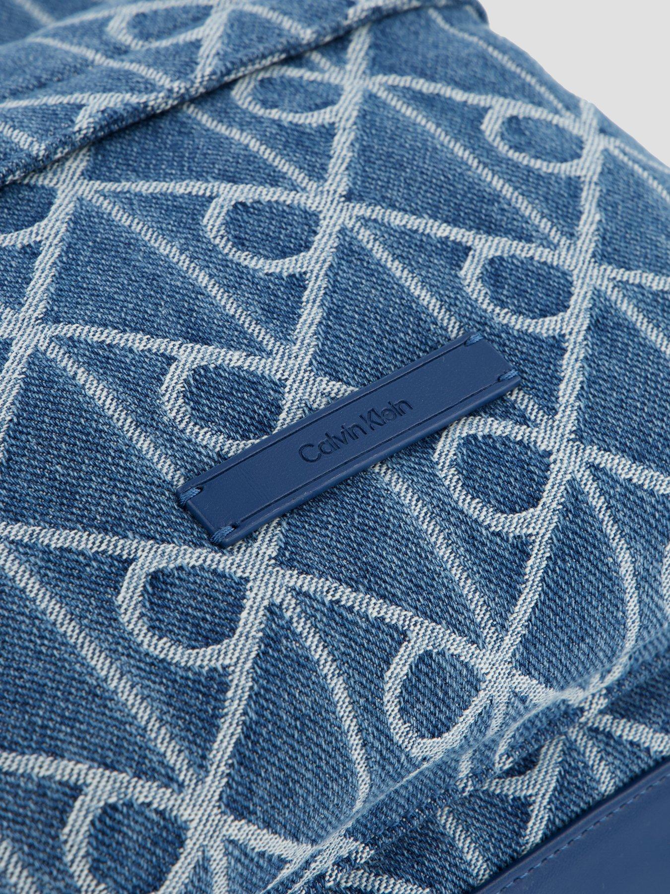 Image 3 of 4 of Calvin Klein Emblem Allover Print Denim Round Backpack - Blue