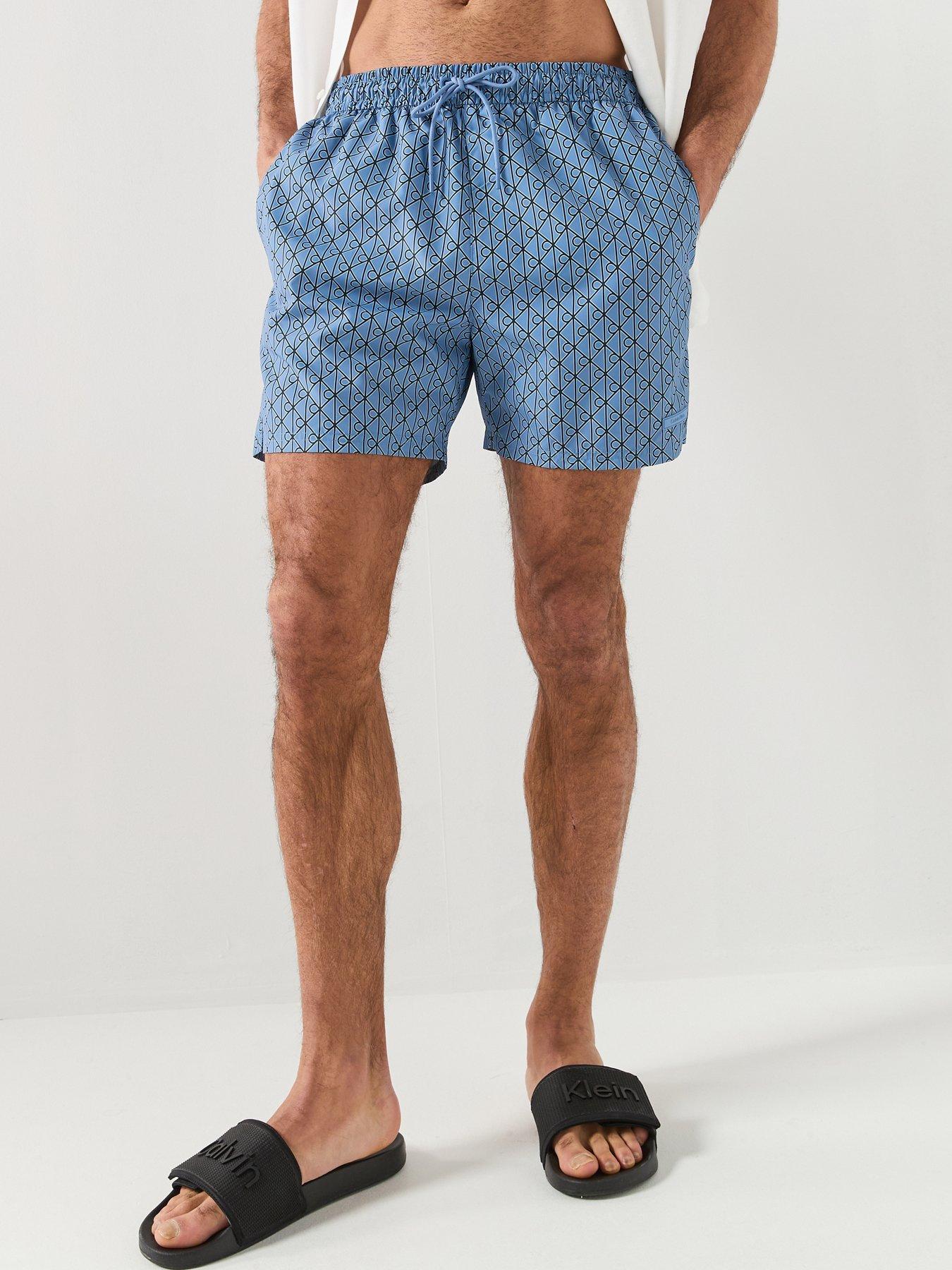 Image 1 of 6 of Calvin Klein Essential All Over Emblem Medium Swim Shorts - Blue