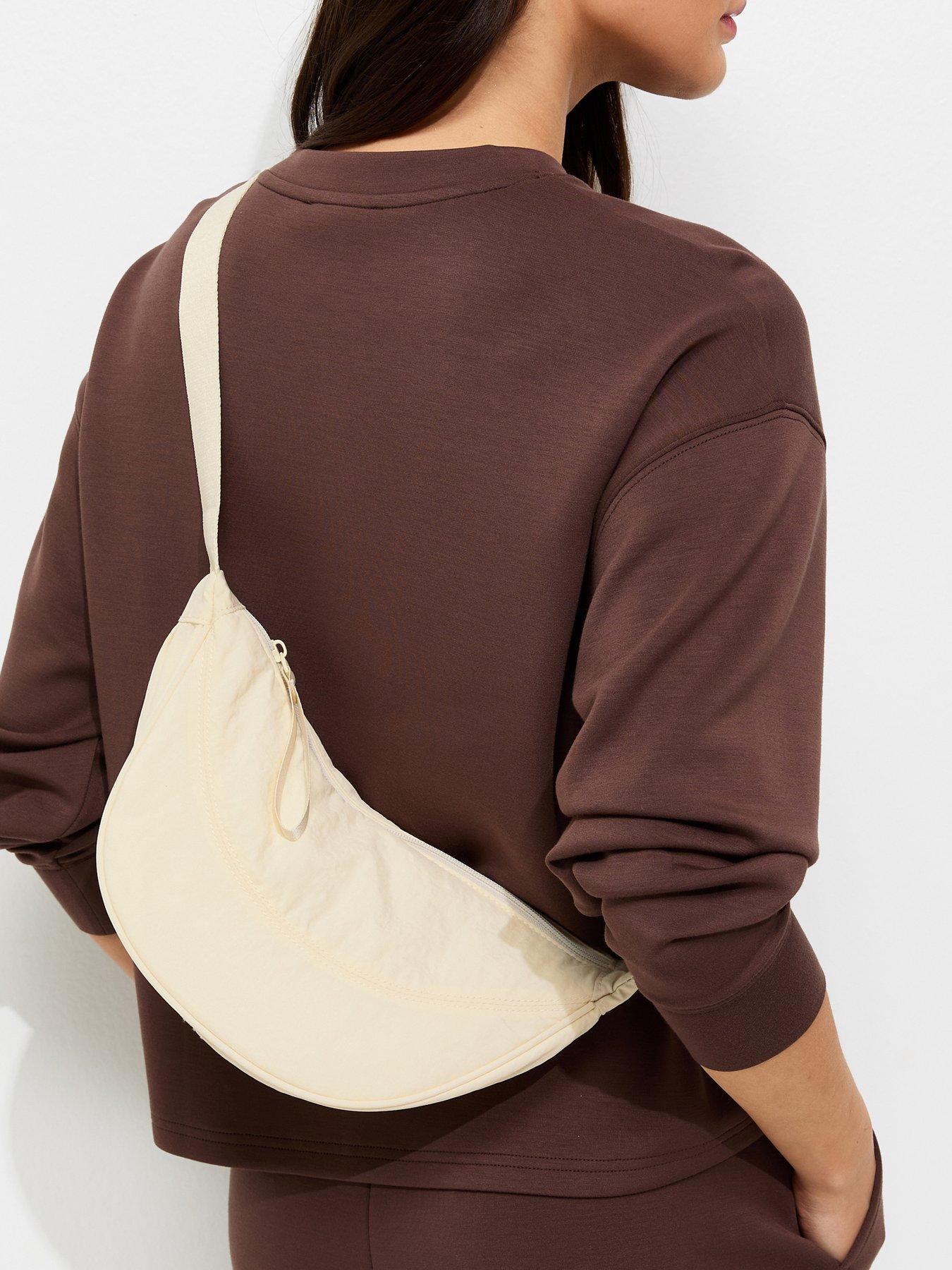 Image 1 of 5 of New Look Plain Curved Crossbody Bag - Cream