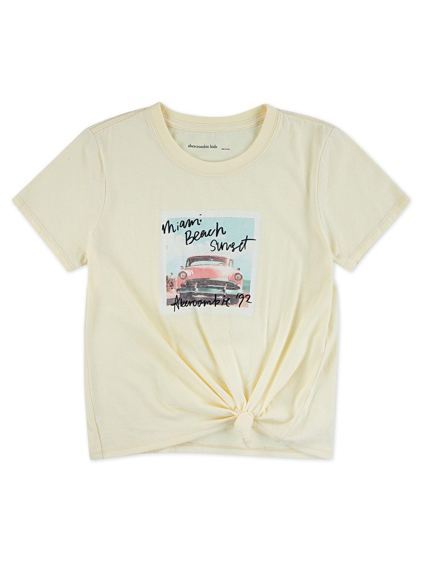 Image 1 of 3 of Abercrombie & Fitch Girls Miami Beach Side Knot Short Sleeve T-Shirt - Yellow