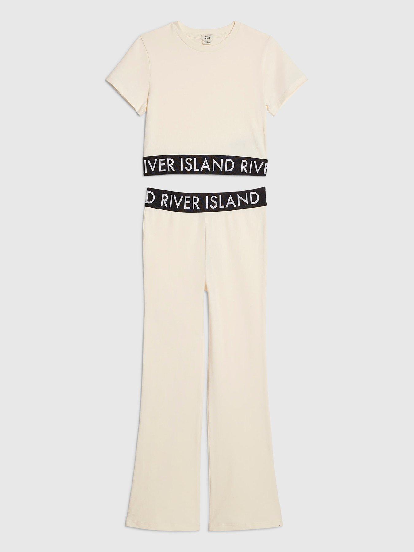 Image 1 of 4 of River Island Older Girls Branded Waistband T-Shirt And Flared Leggings Set - Cream